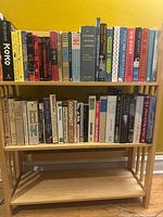 Full view of three-tier folding shelf with books on two shelves