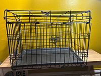 full view of metal wire dog crate with tray