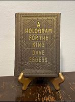 Front cover showing gold embossed title and wood-grain texture