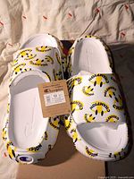 Top view of new Champion clogs showing size tag and all-over logo print