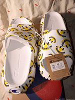 Top view of new Champion foam clogs showing logo print, size tag, and box