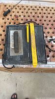 Top view of wet saw with yellow rip guide and stone on table