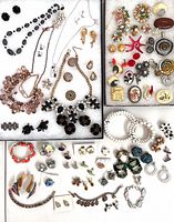 Overall view of entire 69-piece jewelry lot laid in two trays