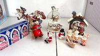 Overview of all Christmas decorations including boxed soap set, Dreamsicles figurines, German smoker, candles, dove ornament