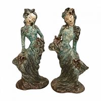 Front view of both ceramic figurine flower holders