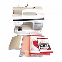 Front view of Husqvarna Viking Platinum 750 sewing machine with manuals and foot pedal