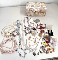 Overall view of jewelry lot and floral jewelry box