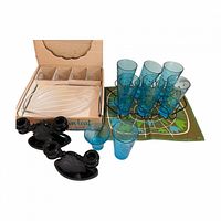 Entire lot showing snack set box, blue glasses in caddy, black candlesticks, placemat