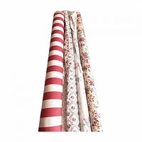 Four fabric rolls standing upright showing the different patterns