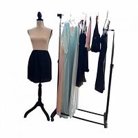 Full view of mannequin with black half slip and clothing rack showing all garments