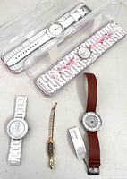 Group shot of five wristwatches showing overall lot contents