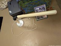 Lamp lying horizontally showing entire tube arm, base, and cord