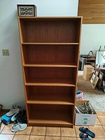 Front view of five-shelf bookcase showing shelves and finish