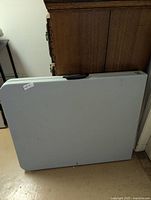 Table folded upright showing exterior panel