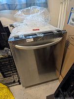 Front view of stainless steel Kenmore dishwasher with curved handle