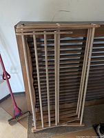 Heater cover with collapsed laundry rack leaning against it