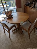 Dining table with three of the chairs around it