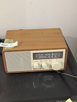 Front and top view of Sangean WR-11 radio showing wood cabinet and controls