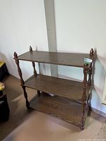 Full view of three-shelf dark walnut display unit