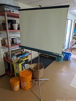 Front view of fully extended Brumberger Rocket projector screen with tripod stand