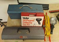 Group shot showing both toolboxes, Weller kit, coiled yellow cord and clamp light