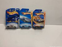 All three sealed Hot Wheels cars side by side
