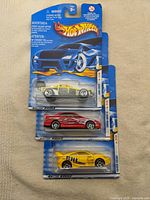 Three sealed Hot Wheels cars stacked: Dune Devil, Honda Civic Si, Toyota Celica