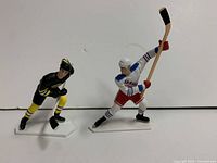 Front view of both Cam Neely and Adam Graves figures on stands