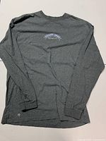 Full view of grey long sleeve shirt showing back logo placement