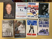 All eight hockey books laid out in two rows