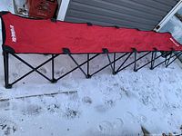 Full length view of extended red six-seat InstaBench on snow