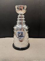 Front view of silver miniature Stanley Cup with Tampa Bay Lightning logo and black base