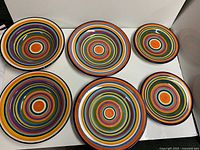Set of six concentric-ring stoneware pieces displayed