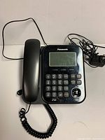 Front view of Panasonic corded phone with handset and cords