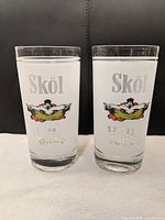 Front view showing both Skol Vodka glasses and printed design