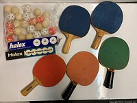 Five paddles, two Halex ball boxes, bag of assorted balls