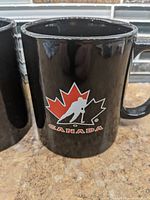 Close-up of mug with maple-leaf hockey player logo
