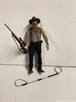 Front view of Rick Grimes figure with rifle and snare pole