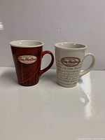 Front view of both Tim Hortons mugs side by side
