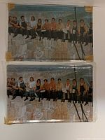 Two identical tin signs in protective wrap