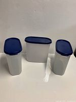 Front view of three canisters with lids on