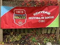 Full view French side of banner attached to fence