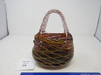 Full view of glass purse-form vessel showing shape and colour pattern