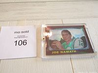 Front view of Joe Namath card in plastic holder