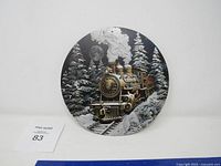 Front view of round metal sign showing train scene