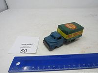 Side view of tin truck with ruler for scale