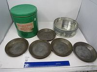 Overall lot view: pretzel tin, silhouette tin, five pans