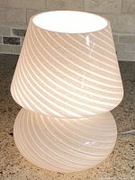 Lamp illuminated showing overall mushroom form and swirl pattern
