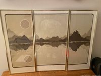 Front view of three framed prints forming panorama