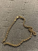 Entire bracelet laid flat showing rope chain and clasp
